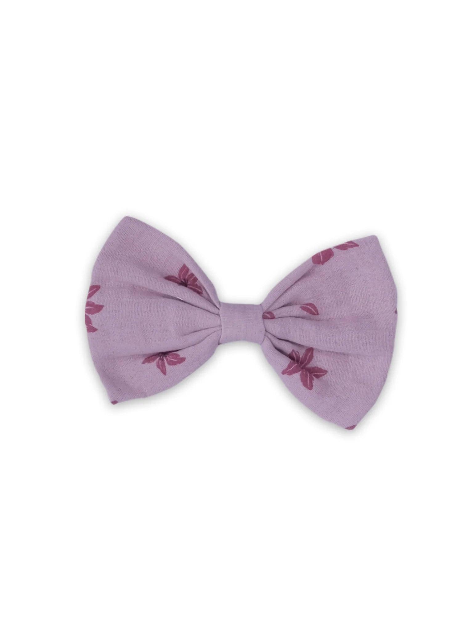 Purple fabric baby hair bow clip with small red floral print on white background