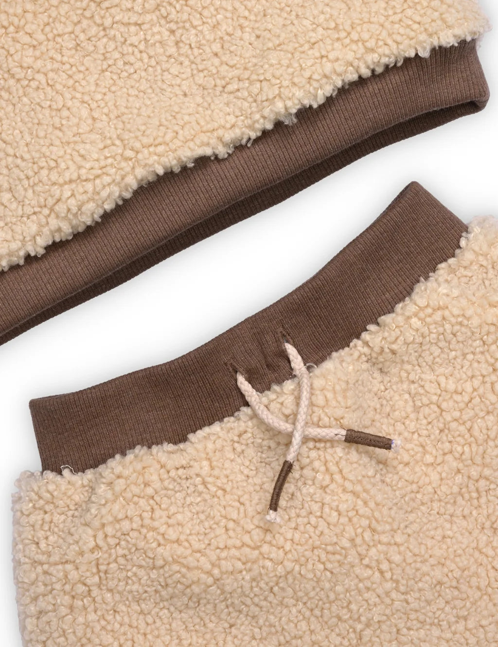 Close-up of a brown and beige fleece garment with a drawstring.