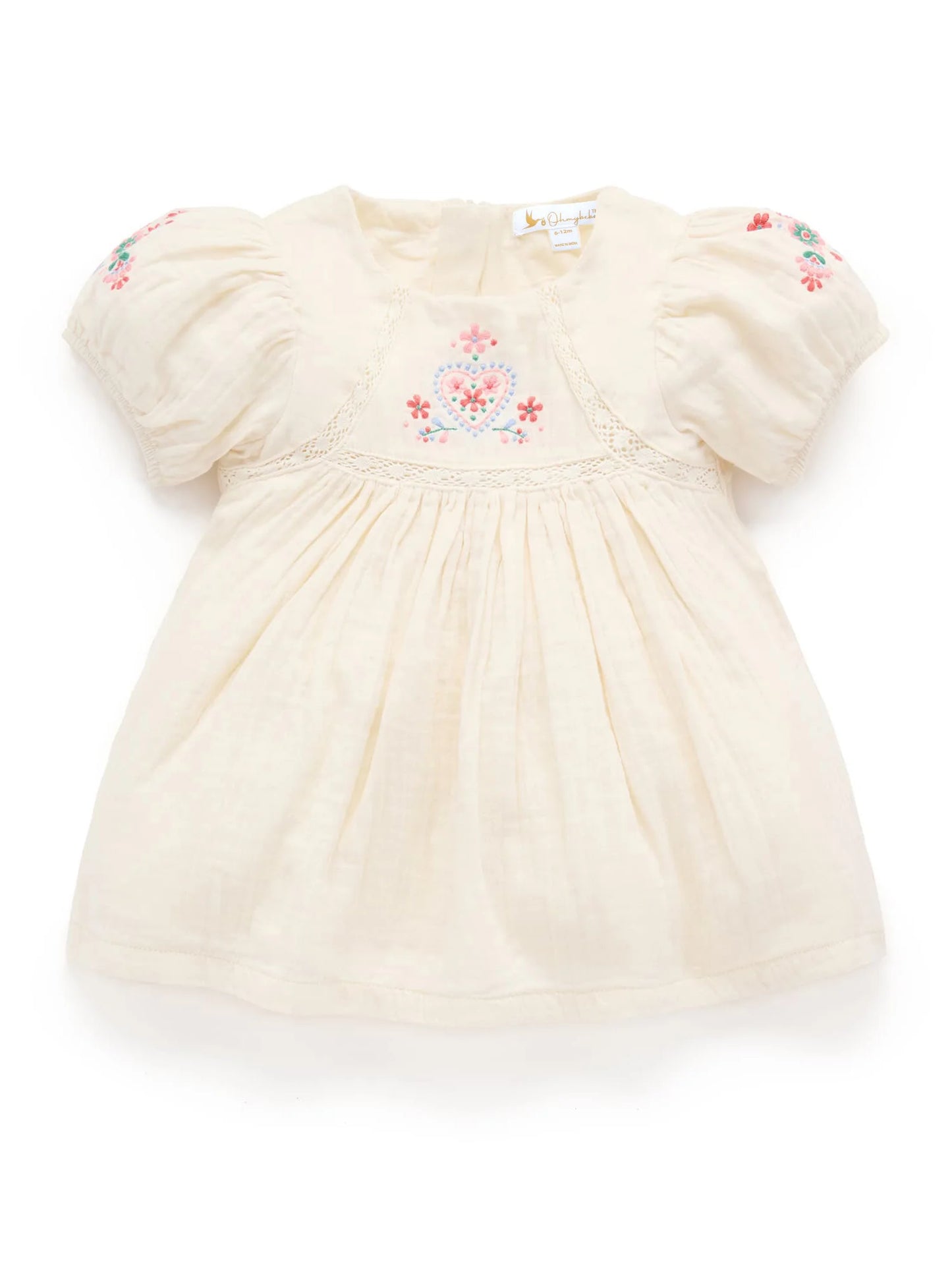 Cream-colored baby dress with floral embroidery on a white background