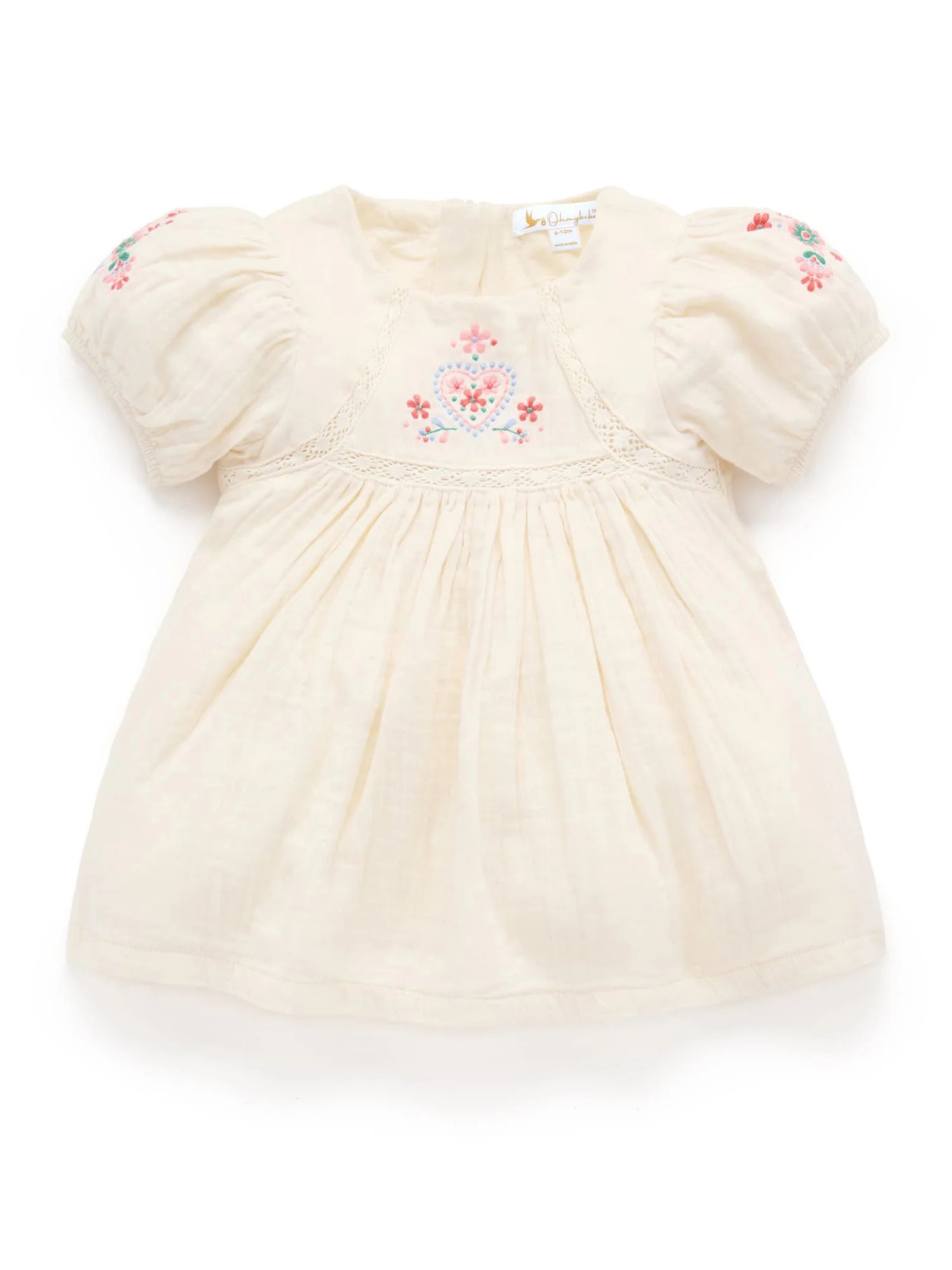 Cream-colored baby dress with floral embroidery on a white background