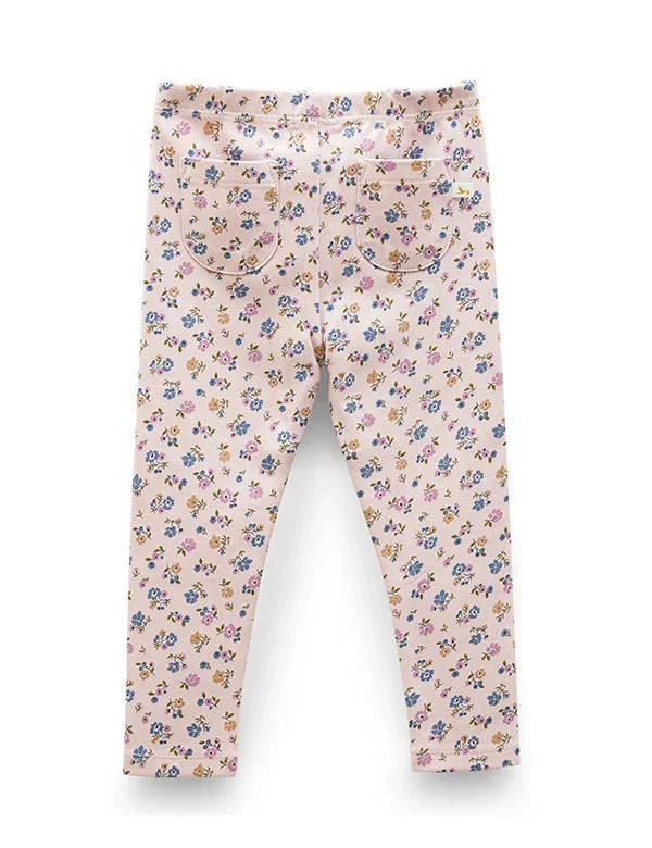 Back view of pink baby leggings with small multicolor floral print and two back pockets
