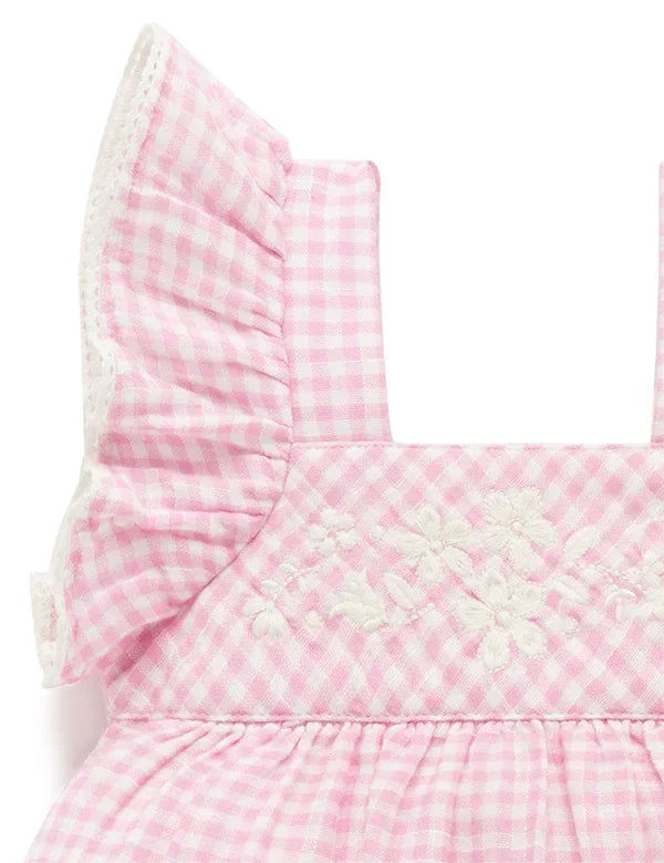 Pink gingham baby dress with ruffled sleeves and white floral embroidery on bodice