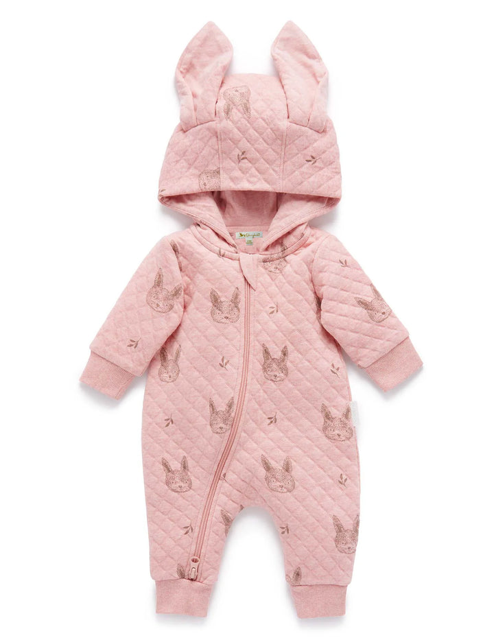 Full view of a soft pink Purebaby quilted growsuit with a hood featuring adorable bunny ear details, a convenient front zipper, and a cute all-over bunny and leaf print. Shop organic baby clothing online in India.