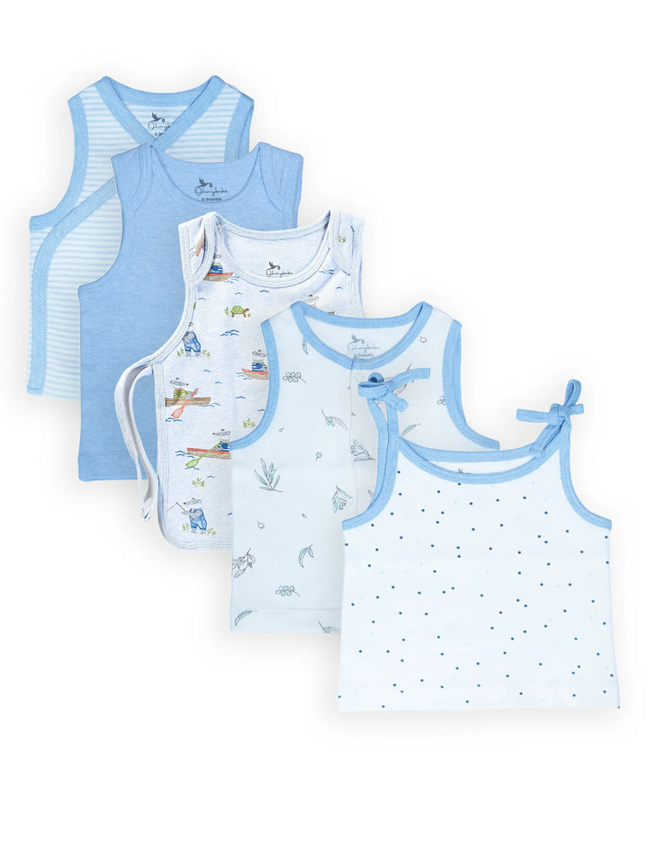 A collection of ohmybebe organic cotton baby singlets featuring different styles like tie-shoulder and cross-over in light blue and white with various prints. Shop natural baby clothing in India.