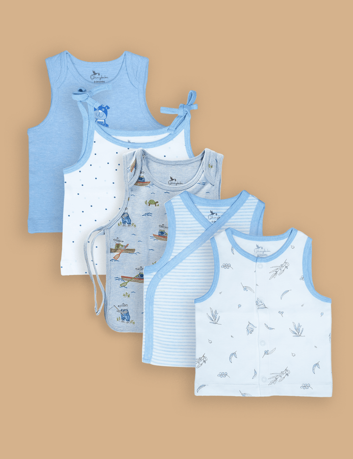 A set of five ohmybebe organic cotton baby singlets in various blue and white designs including stripes, polka dots, and animal prints. Shop gentle baby undershirts online in India.