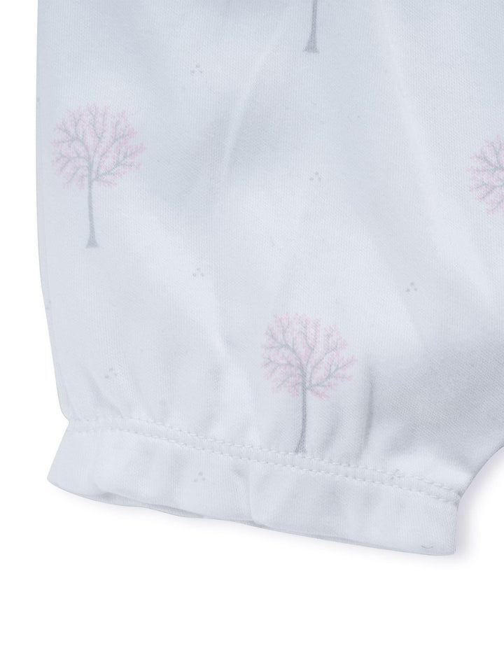 Detail of the white organic cotton baby bloomers showing the elasticated waist and the soft ruffled leg opening with the winter tree print. Shop adorable baby bottoms India.