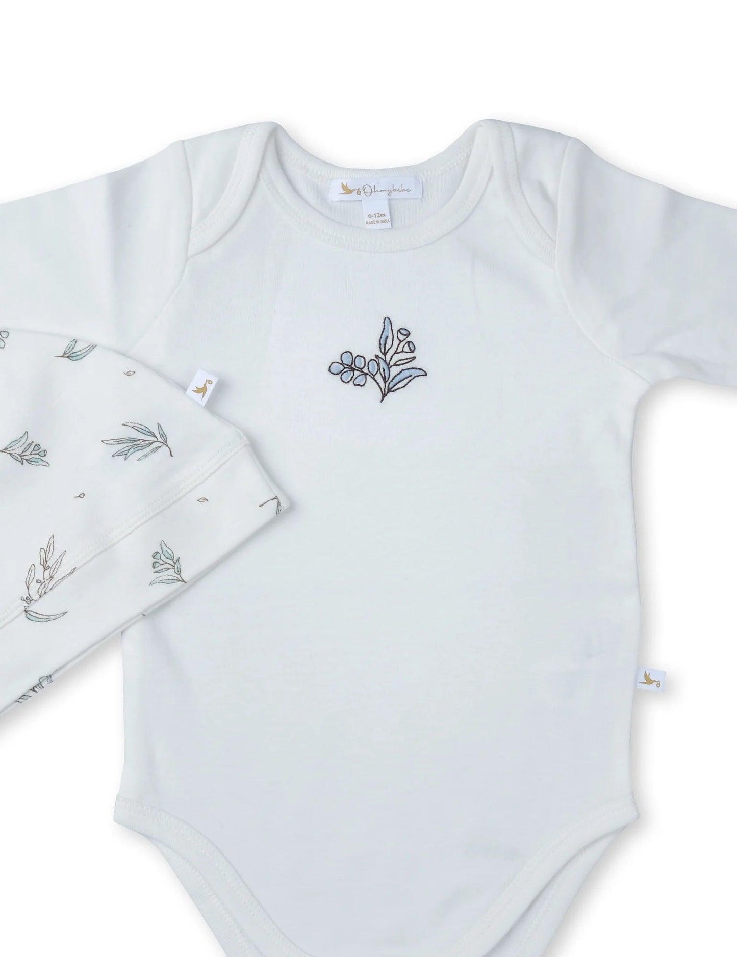 White organic cotton baby bodysuit with blue floral embroidery and matching hat with leaf print