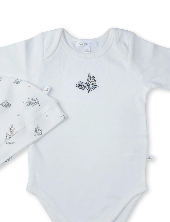 Soft white 100% organic cotton long-sleeve baby bodysuit with a subtle embroidered detail on the chest. Part of a gentle baby clothes set. Shop online India.