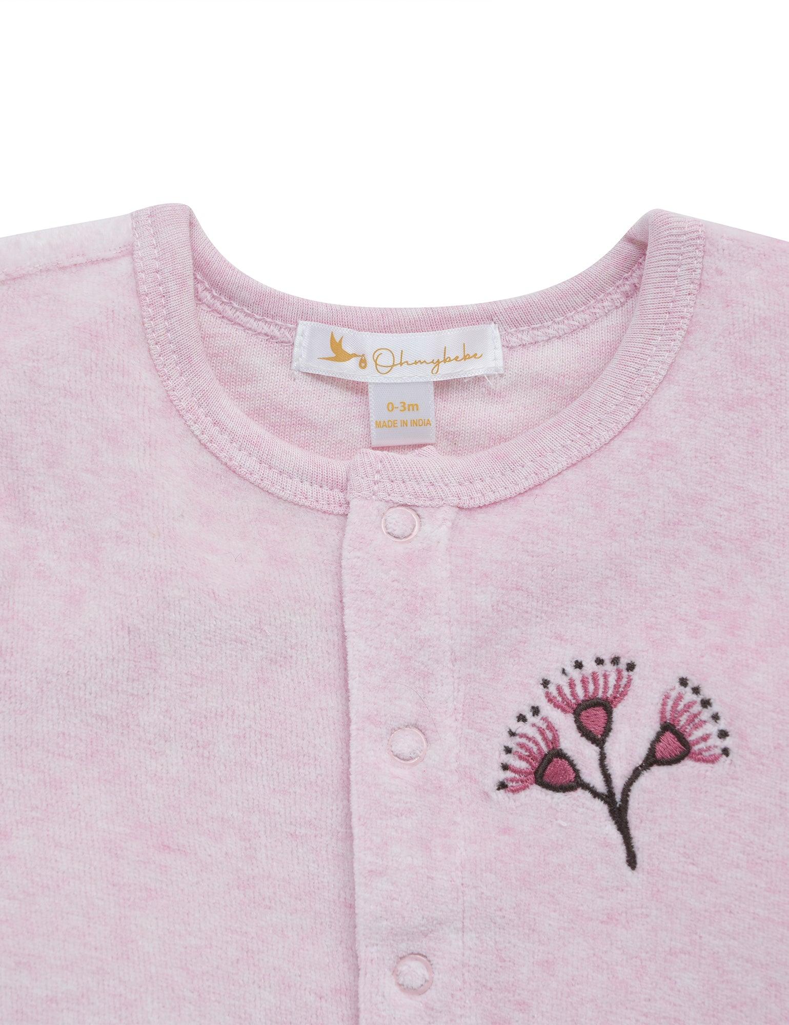 Close-up of pink organic cotton baby cardigan with hand-embroidered floral design and snap buttons