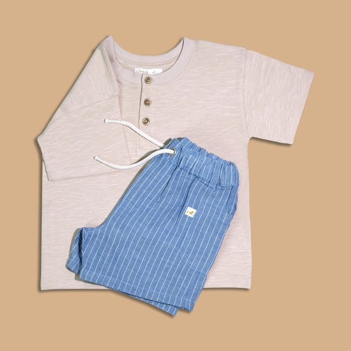 100% organic cotton beige baby henley t-shirt with button detail, paired with soft blue and white striped shorts with a drawstring waist. Buy organic baby clothes India.