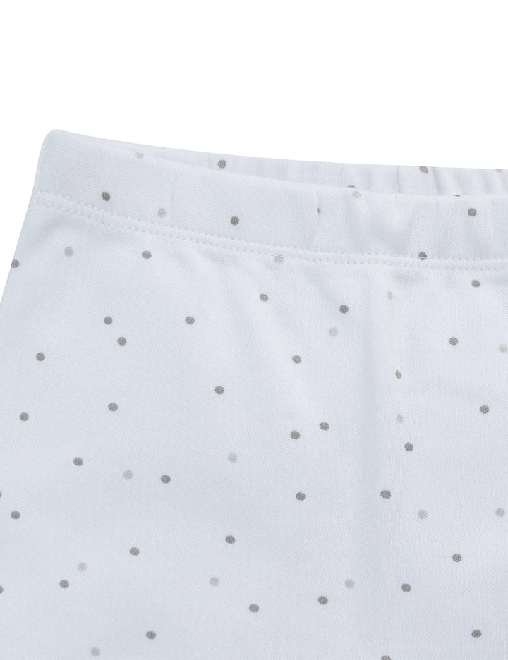  Detail of the white organic cotton baby leggings with grey dots, highlighting the comfortable elastic waistband. See practical baby wear India.