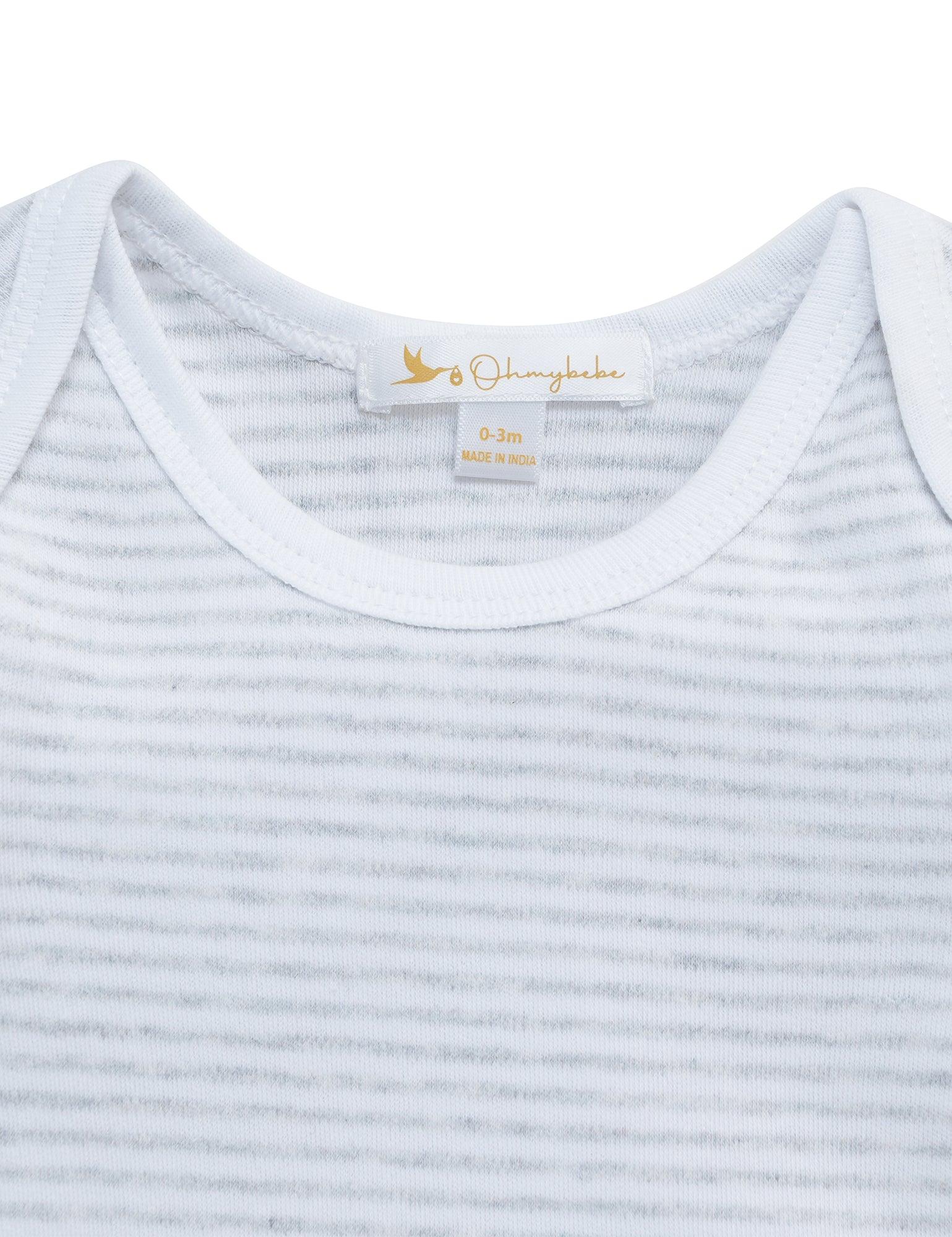 Close-up of white and gray striped organic cotton baby onesie neck label showing size 0-3 months
