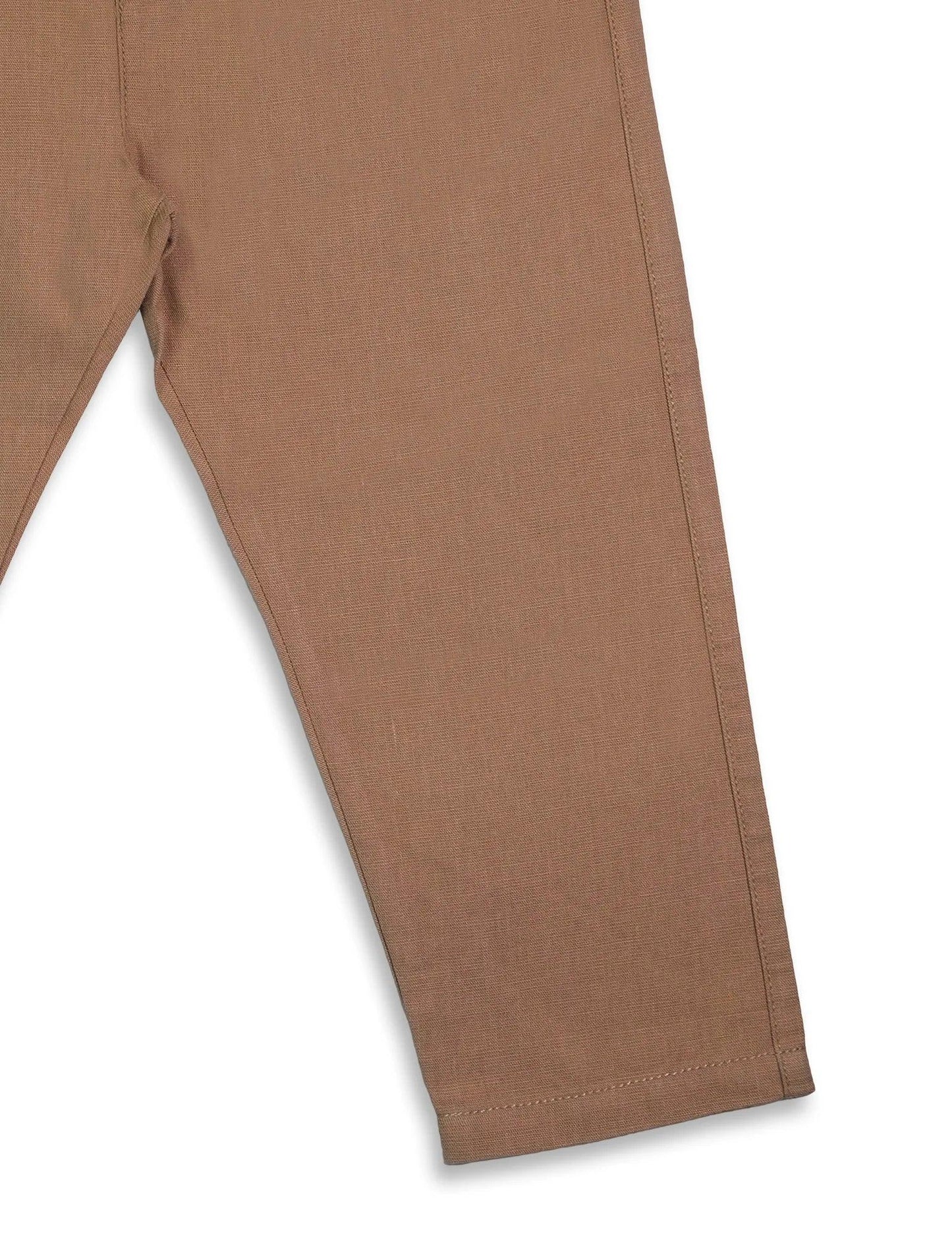 Close-up of brown organic cotton baby pants leg with detailed stitching