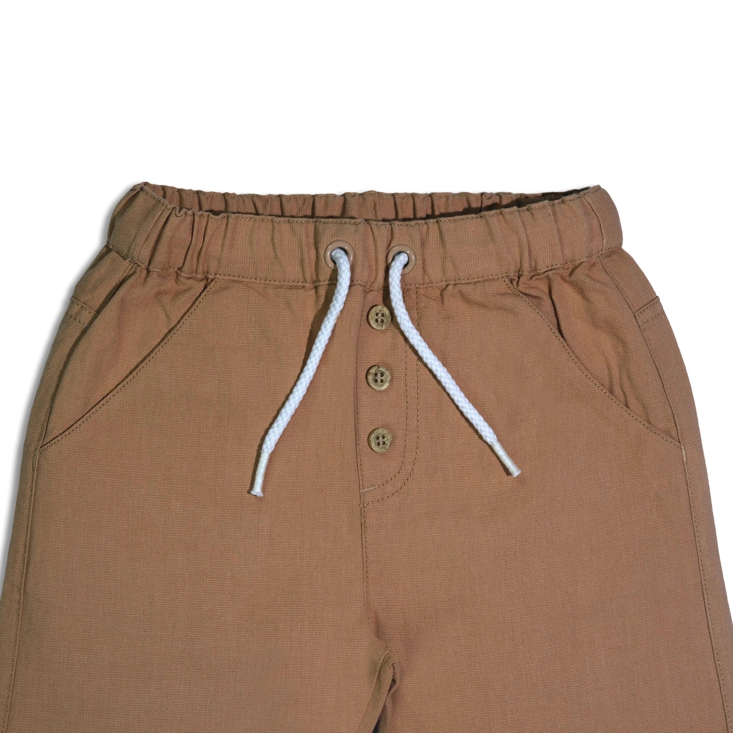 Organic cotton baby pants waist detail with elastic band, white drawstring, and beige buttons