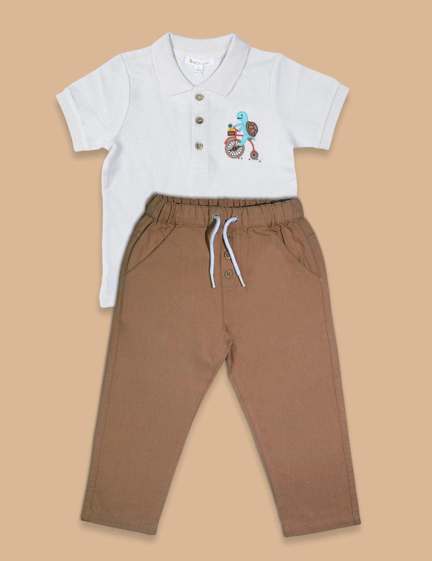 Organic cotton baby polo shirt with turtle bike embroidery and brown drawstring pants flatlay