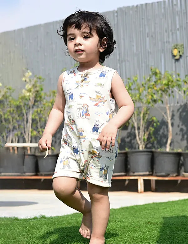 Adorable toddler, who appears to be of South Asian descent, wearing a 100% organic cotton printed romper. A stylish and comfortable choice for babies. Shop organic baby rompers India.