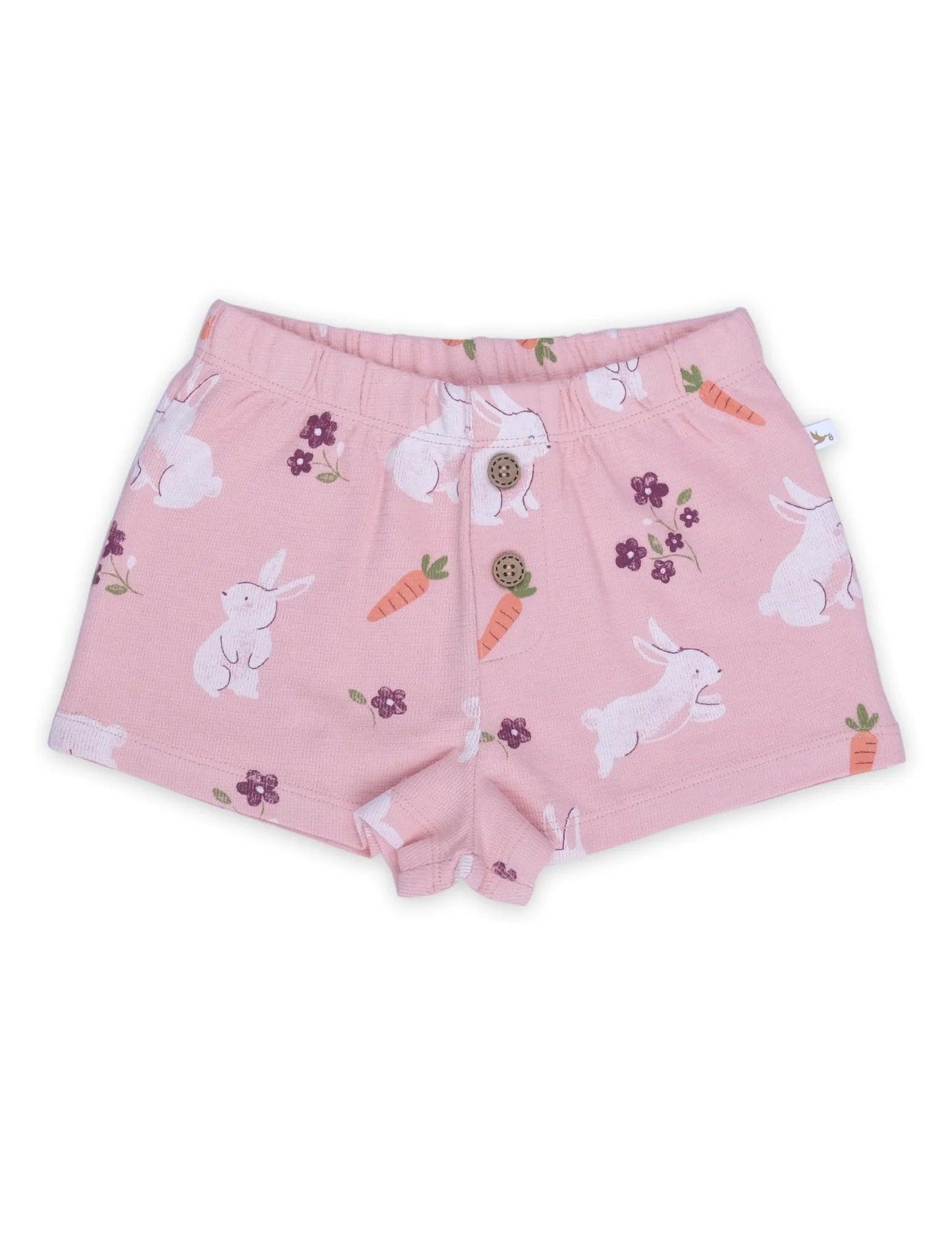 Pink organic cotton baby shorts with white bunny, carrot, and purple flower print, two wooden buttons