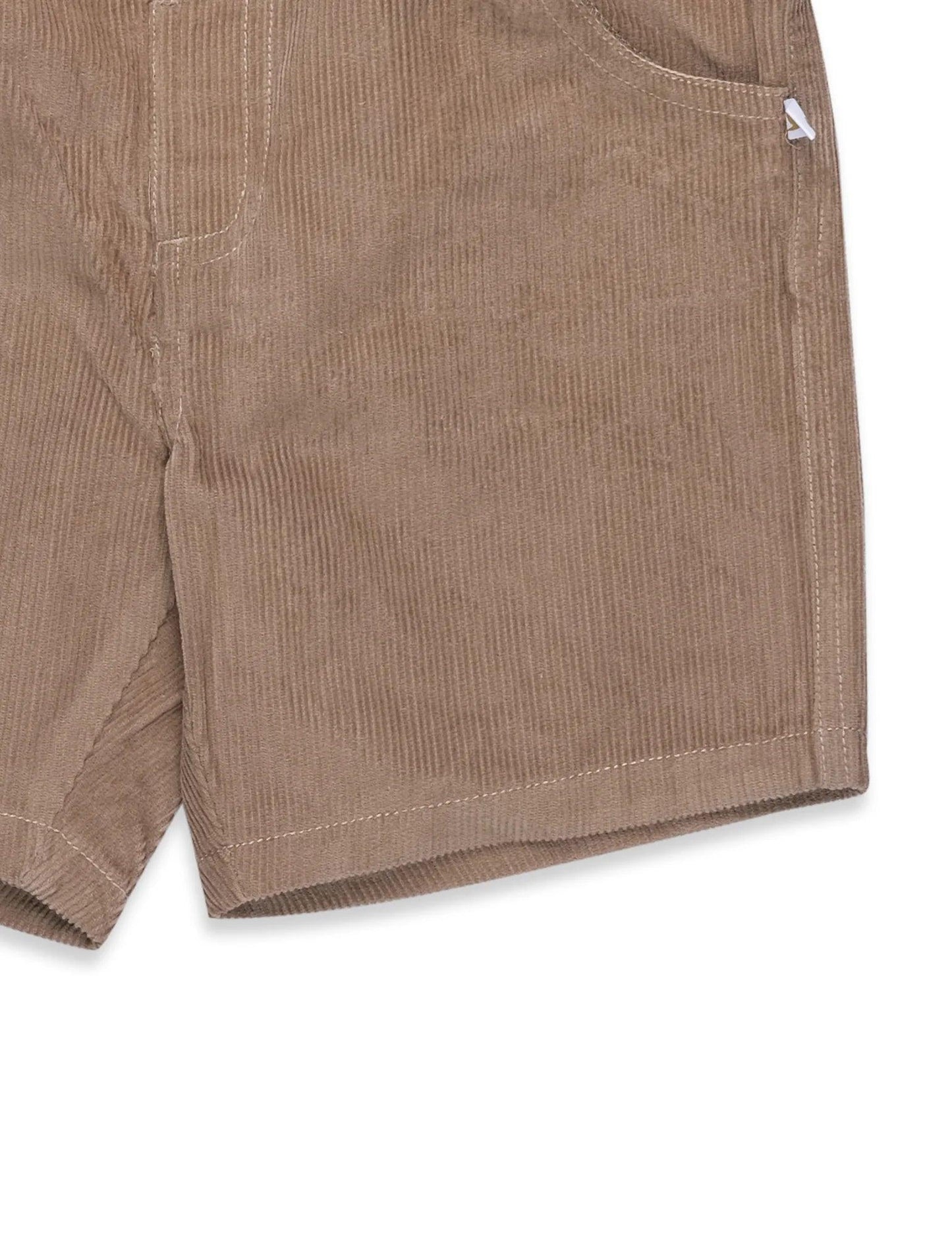 Close-up of beige organic cotton corduroy baby shorts with pocket detail