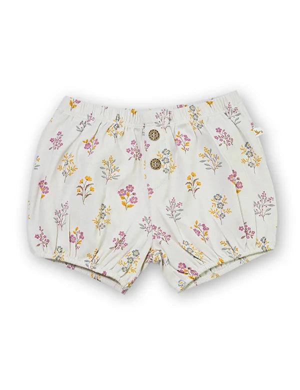 Organic cotton baby shorts with pink, yellow, and blue floral pattern and two front buttons