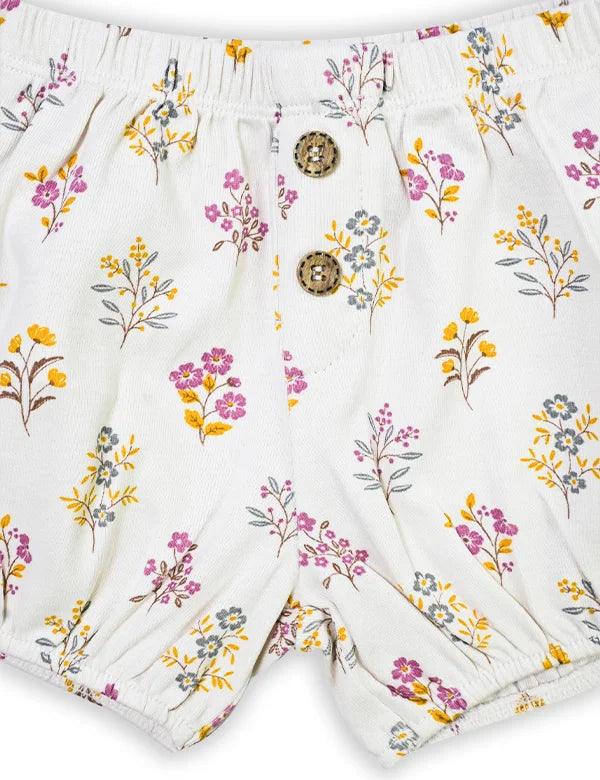 Organic cotton baby shorts with elastic waist and floral print in yellow, pink, and gray with wooden buttons