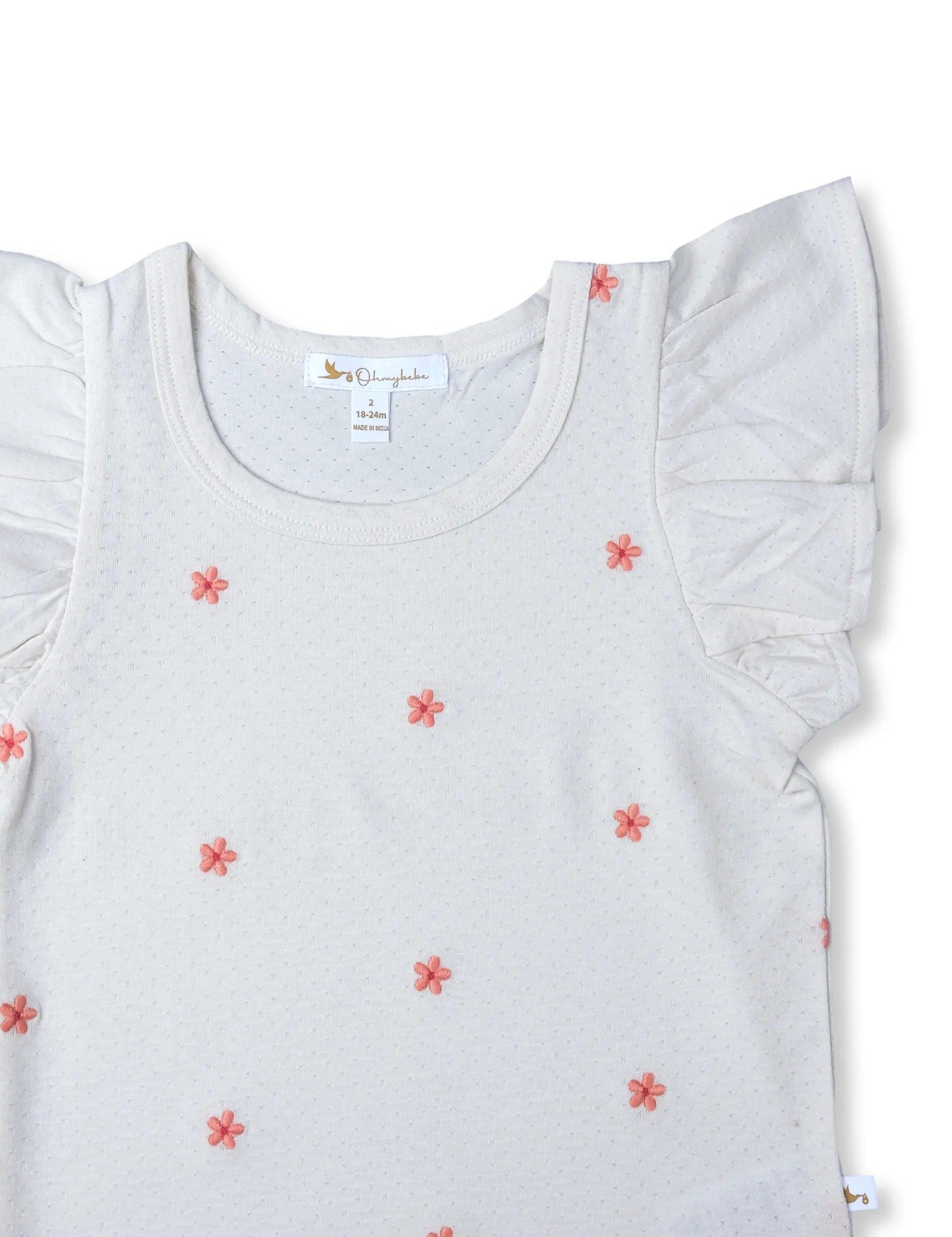 White organic cotton baby tee with pink floral embroidery and ruffled sleeves, size 18-24 months