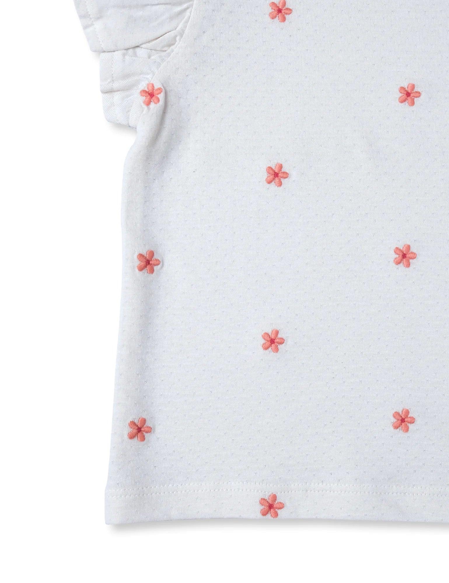 White organic cotton baby tee with pink embroidered flowers and ruffle sleeve detail