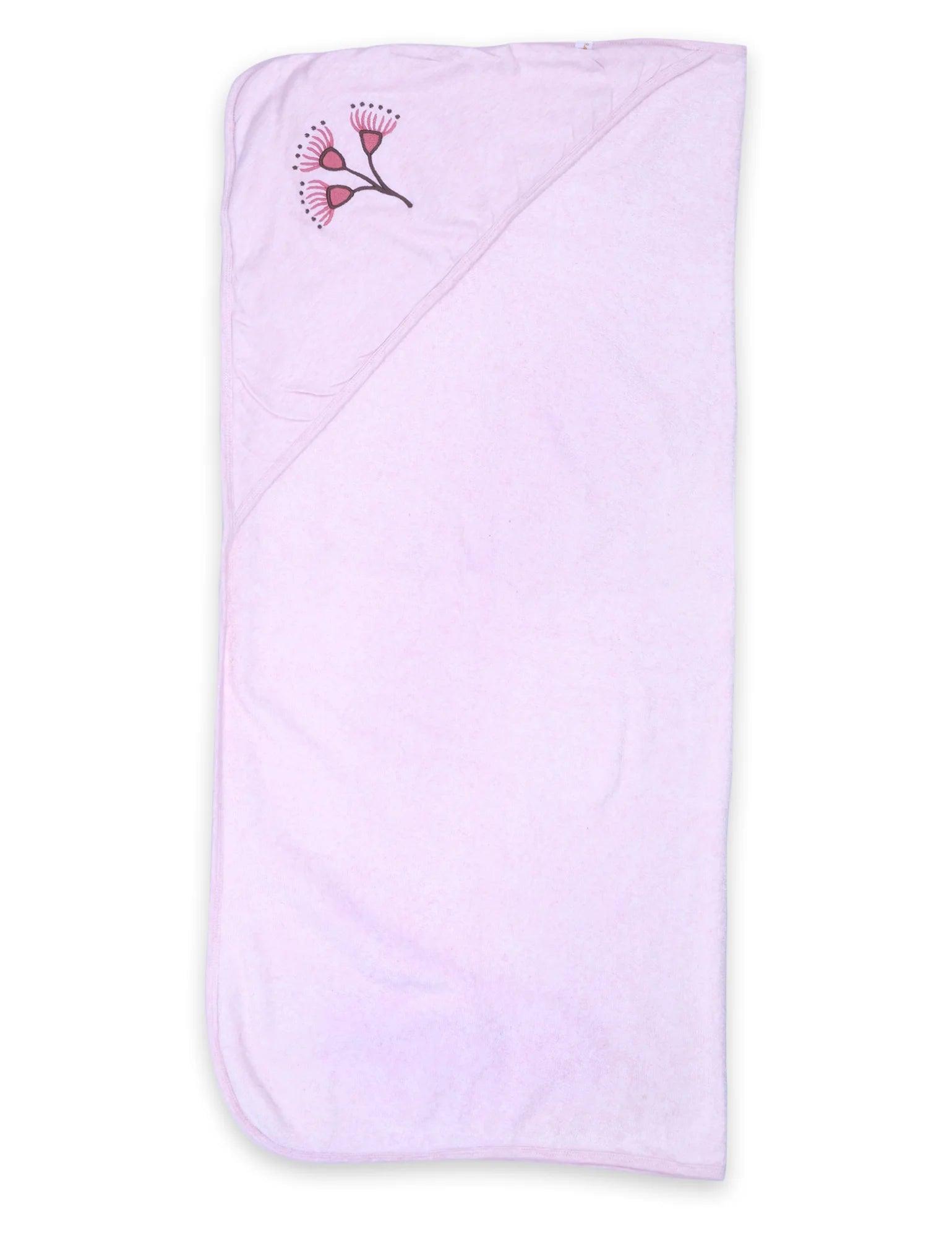 Light pink organic cotton baby towel with floral hood design folded flat on white background