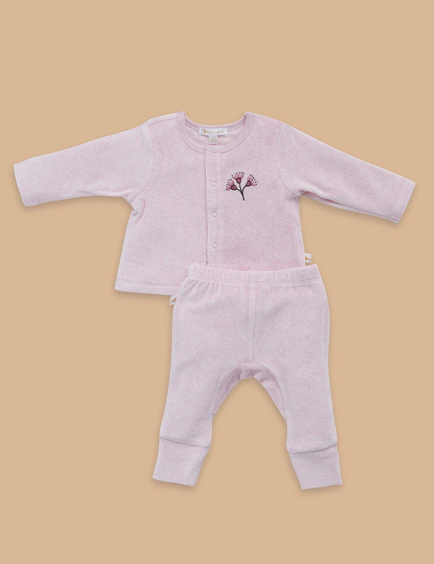 Soft pink organic cotton baby cardigan and pants set with floral embroidery on chest, flatlay