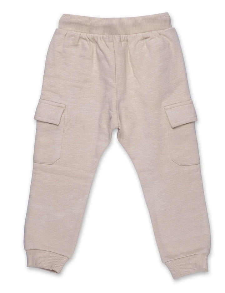 Comfortable beige organic cotton cargo pants for babies with an elasticated waistband, drawstring, and functional side cargo pockets. Buy organic baby pants India.