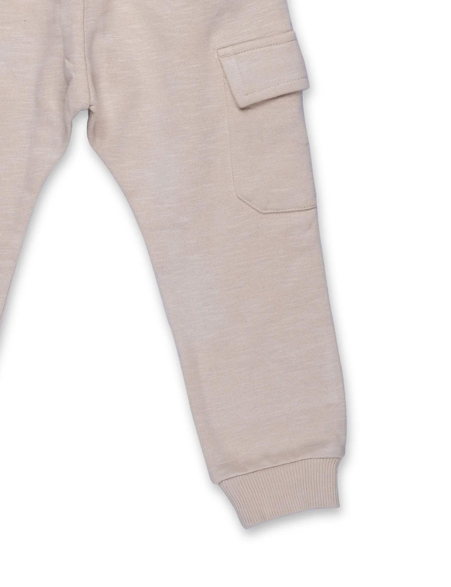 Beige organic cotton cargo pants leg detail with side pocket and ribbed cuff