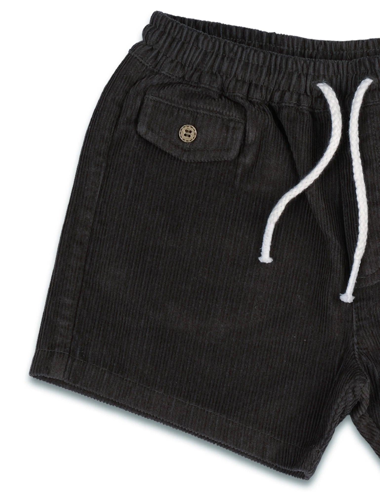 Black organic cotton corduroy shorts with elastic waistband, white drawstring, and buttoned pocket