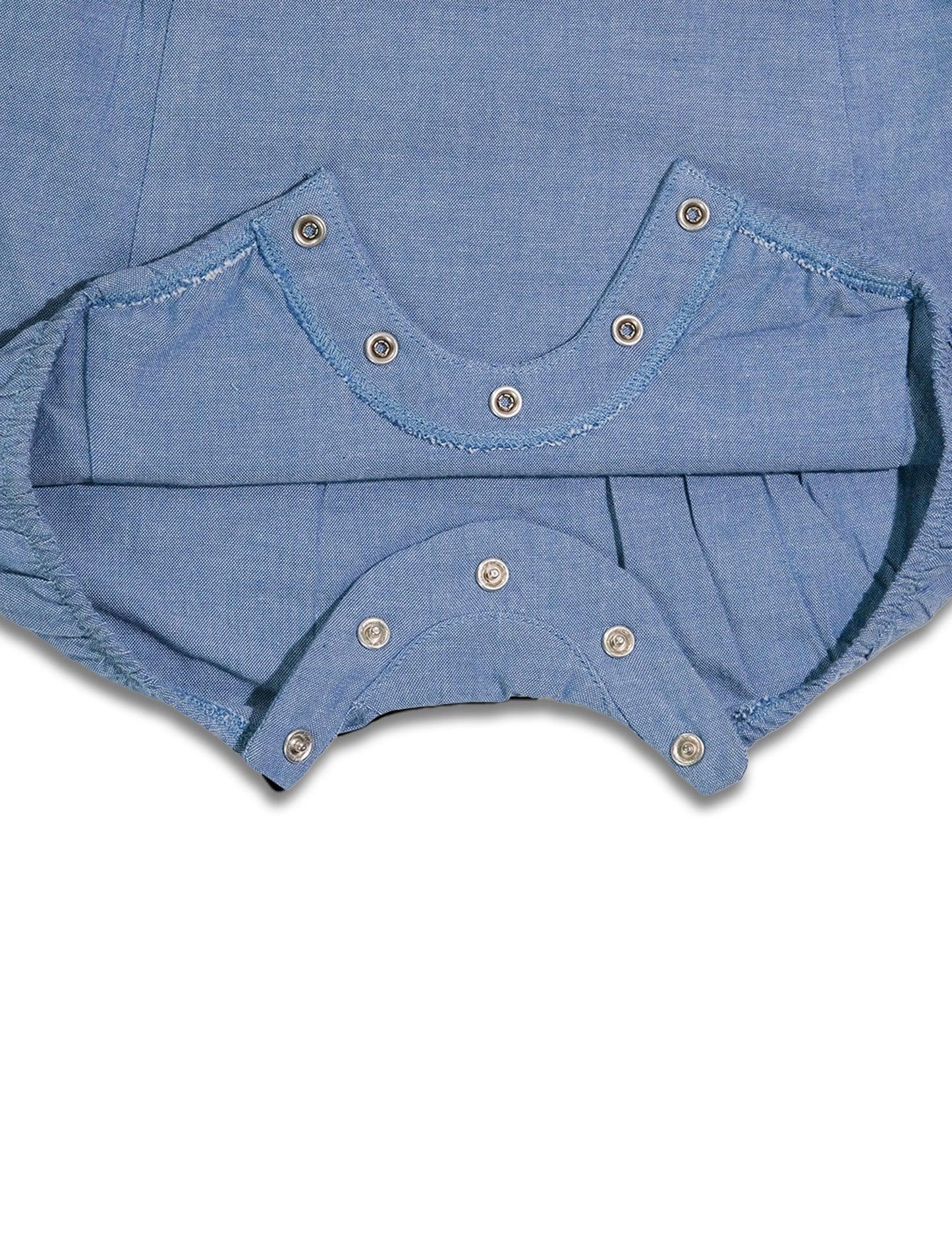 Close-up of blue organic cotton dungaree snap button closure with metal snaps