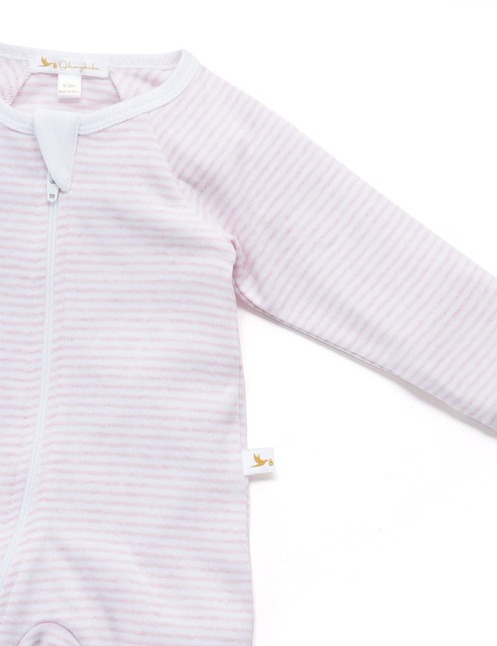 Gentle white organic cotton baby footed pajamas with thin pink stripes and a practical zip front. Comfortable for baby's sleep. Buy striped baby sleepsuits India.