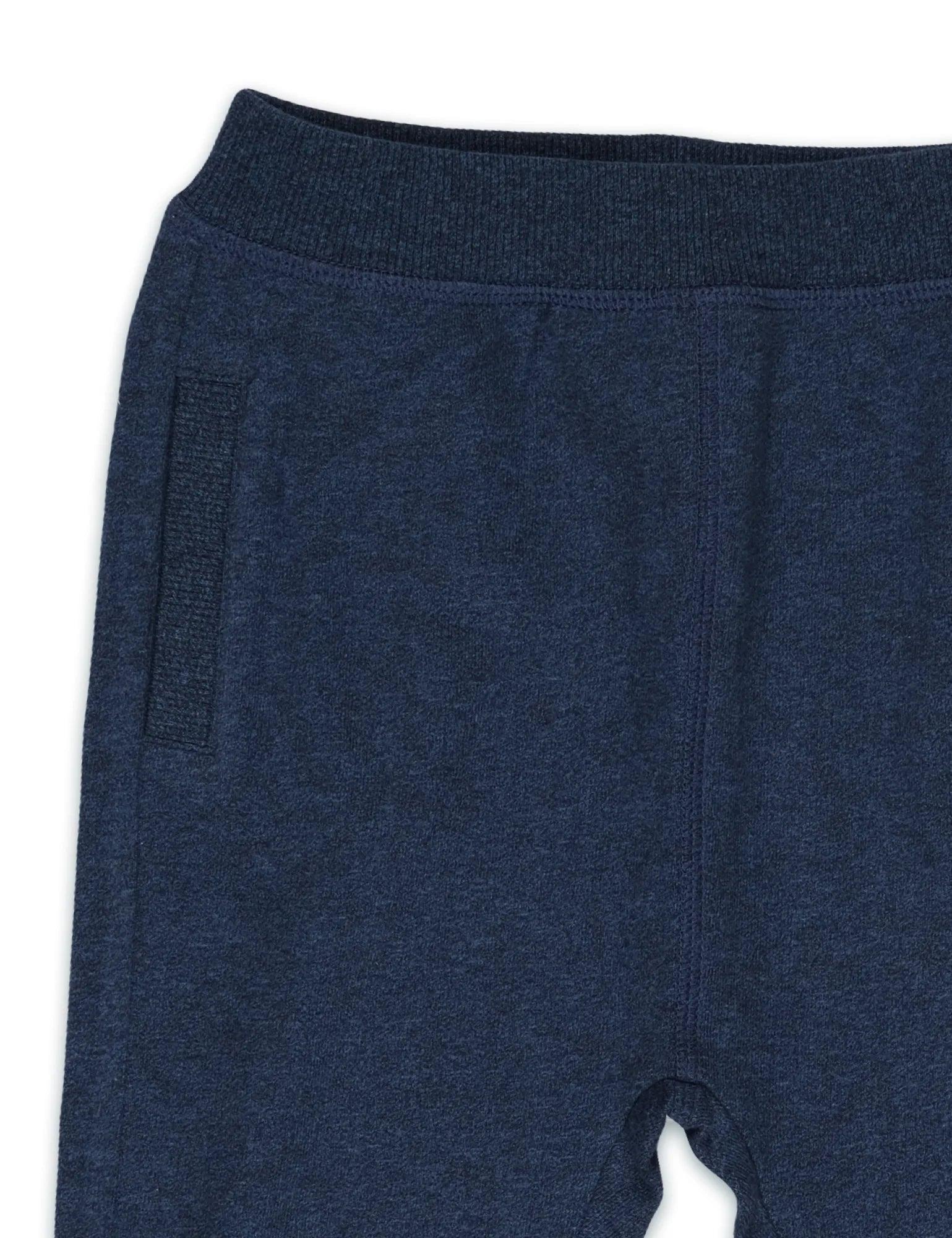 Close-up of navy blue organic cotton joggers with ribbed waistband and side pocket detail