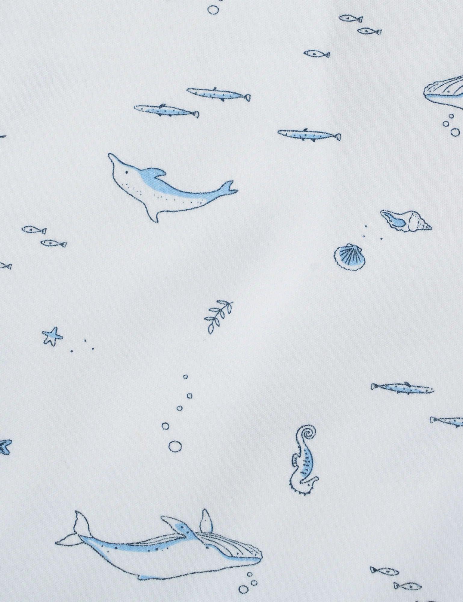 Organic cotton muslin fabric with blue ocean print of dolphin, whale, seahorse, fish, and shells