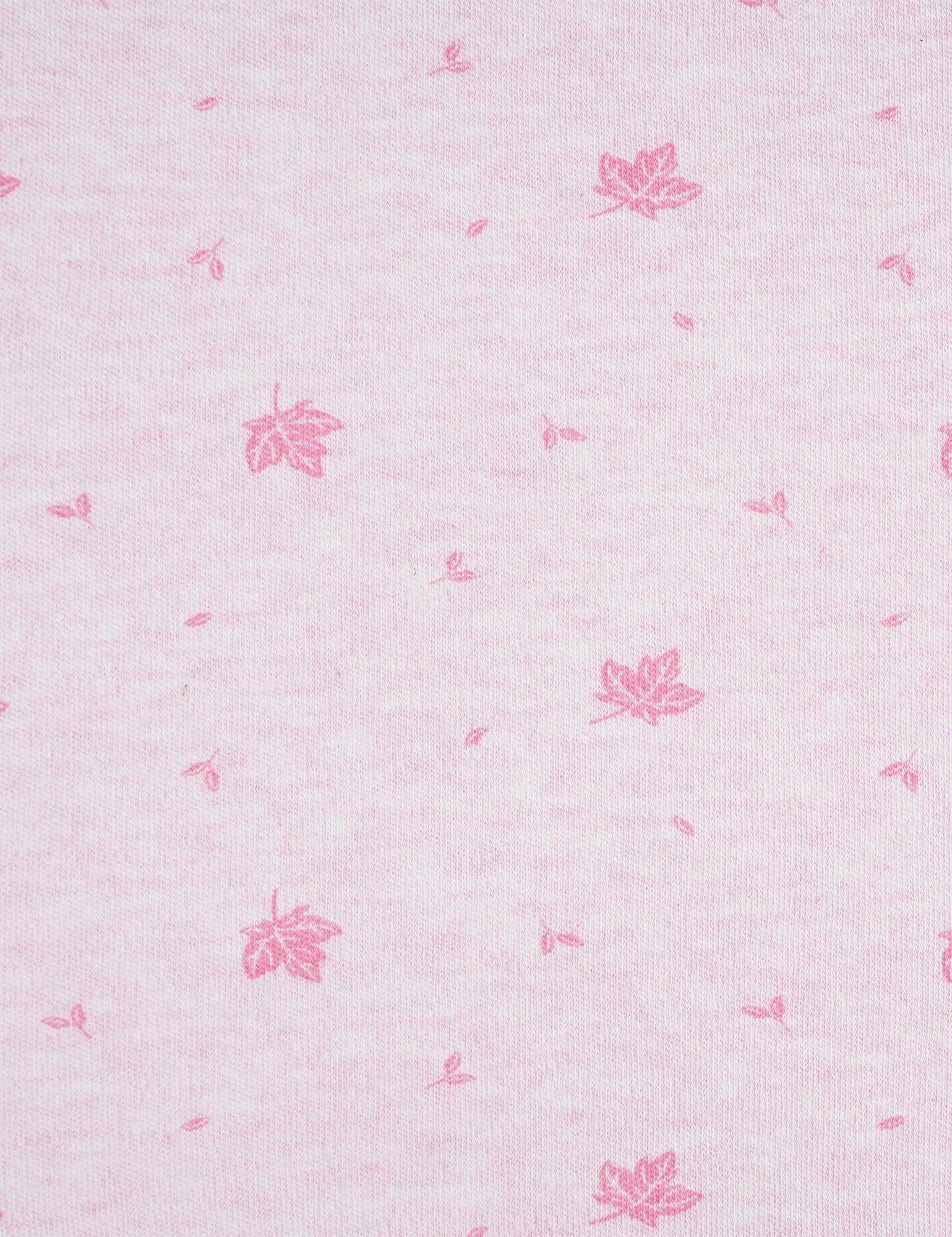 Close-up of pink organic cotton muslin fabric with small printed pink maple leaf and seed patterns