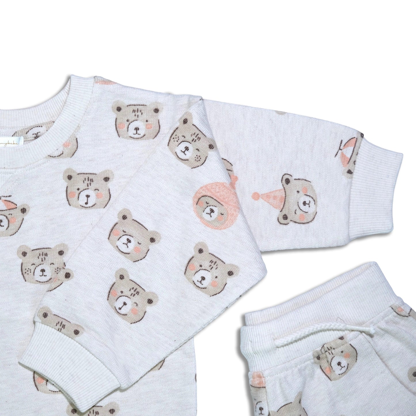 Organic cotton baby pajamas with festive bear print in soft beige and pink tones