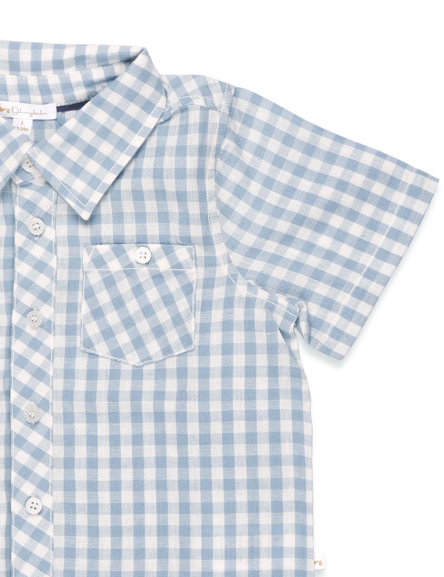 Close-up of blue and white gingham short sleeve organic cotton shirt with front pocket and buttons