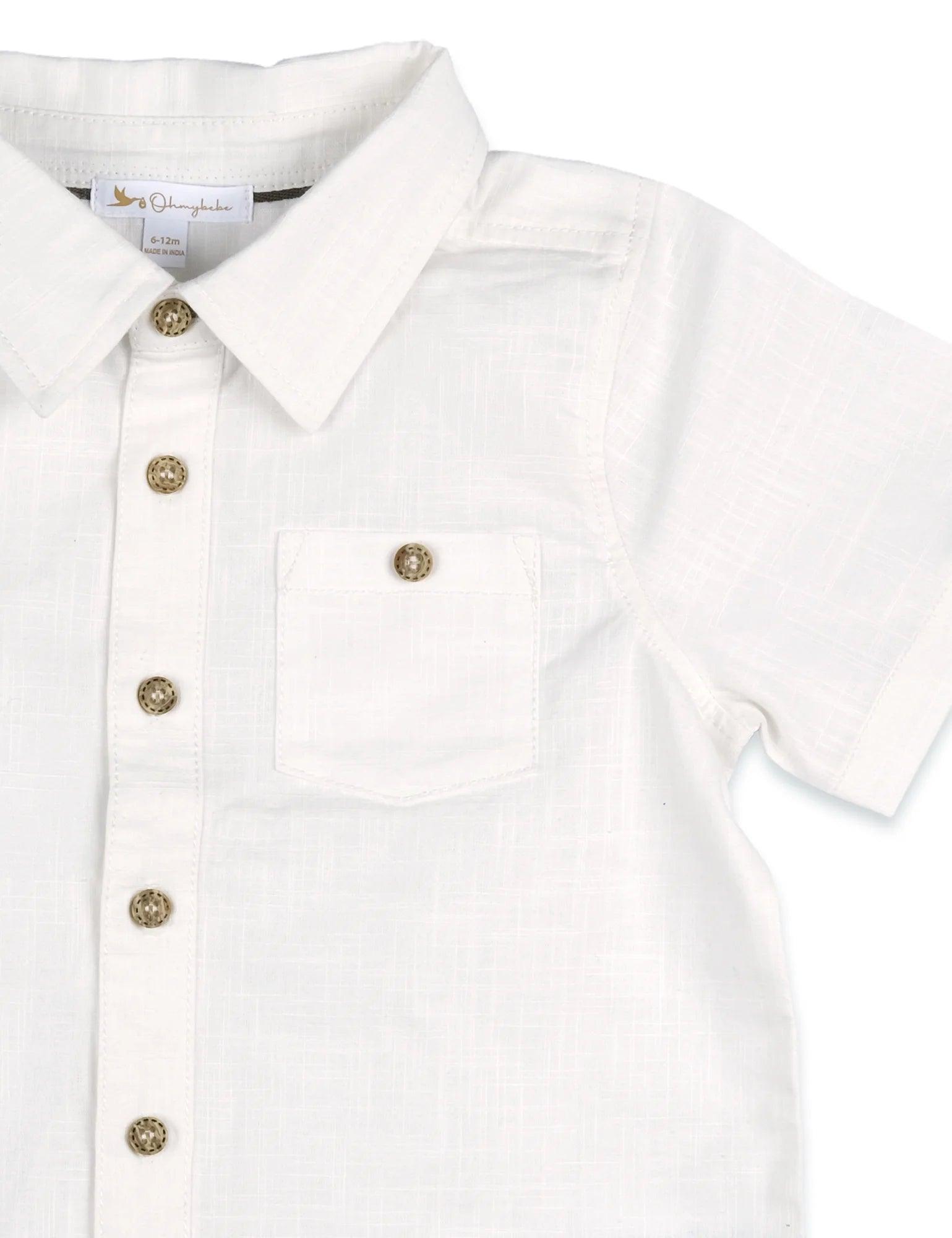 Close-up of white organic cotton toddler shirt with short sleeves, buttons, and chest pocket