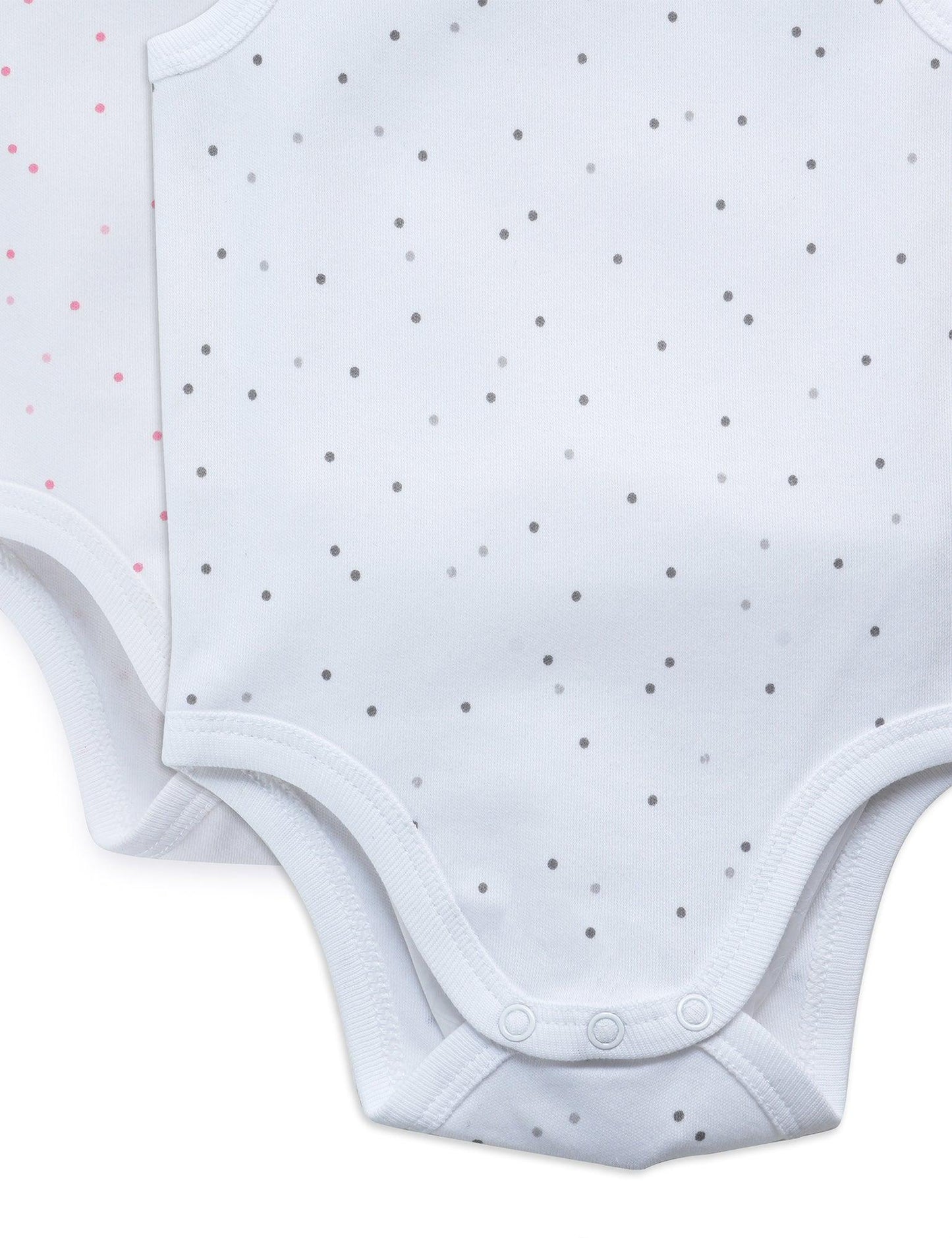 Close-up of white organic cotton sleeveless baby bodysuits with grey and pink dot patterns and snap closures