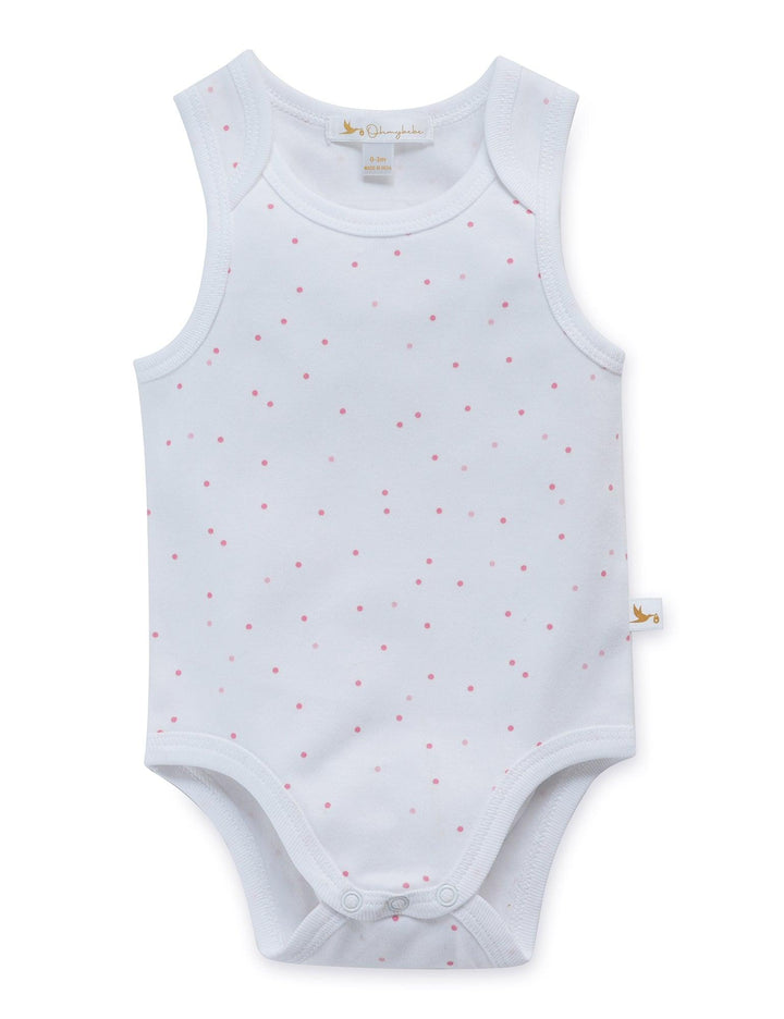 White organic cotton baby sleeveless bodysuit with an all-over pattern of small pink dots and comfortable snap closures. Shop essential baby wear India.