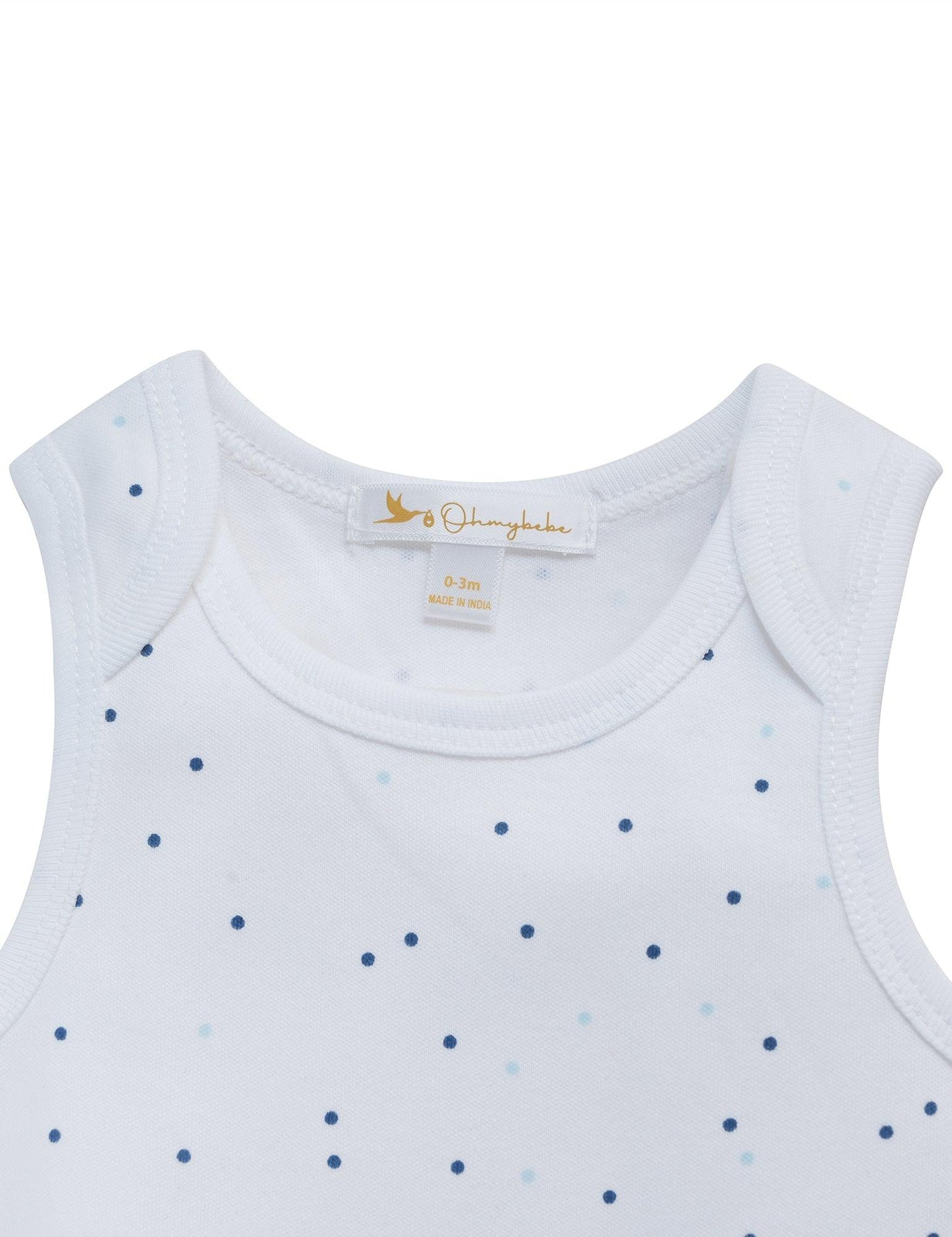 Close-up of white organic cotton sleeveless baby bodysuit with tiny blue dots, size 0-3 months