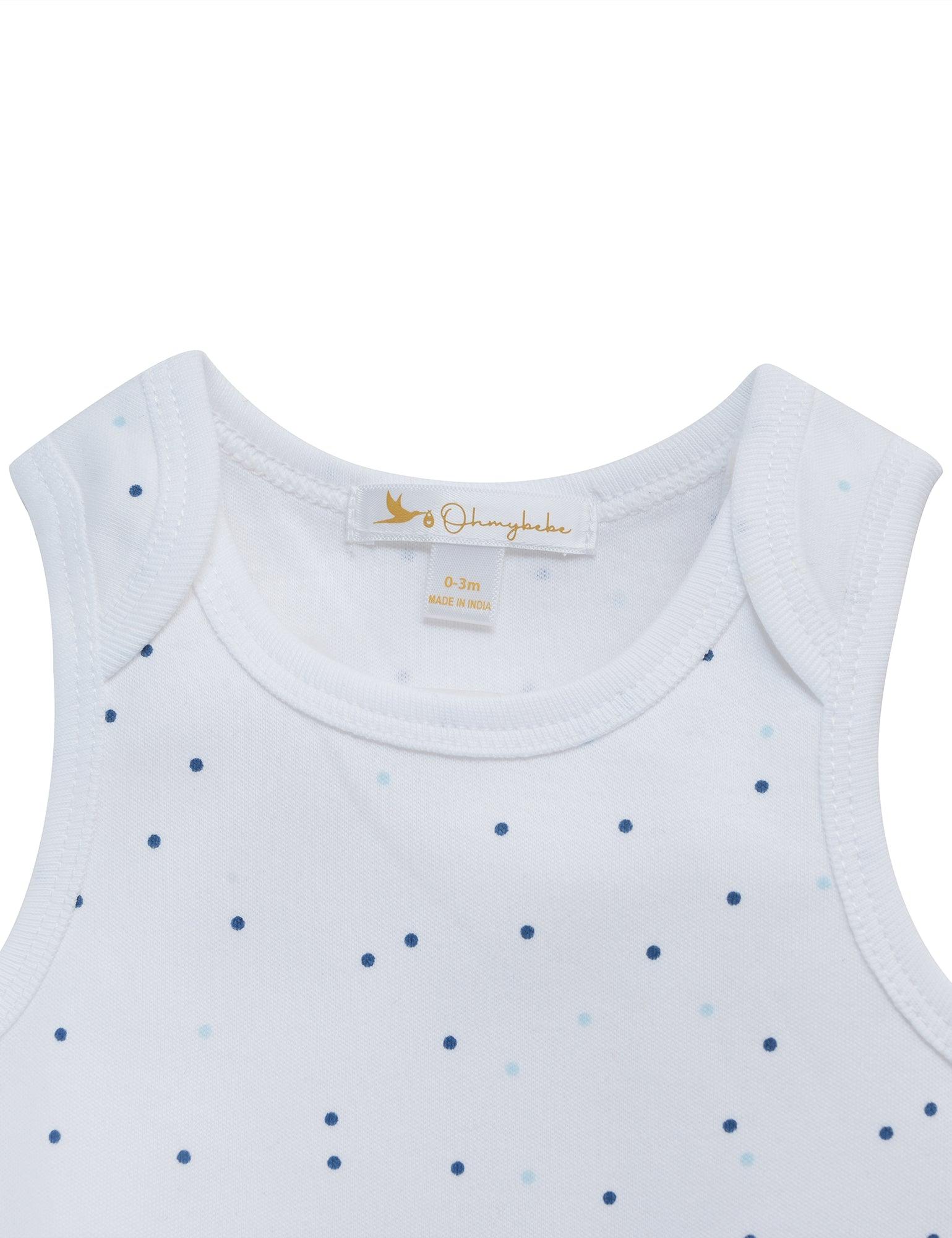 Close-up of white organic cotton sleeveless baby bodysuit with tiny blue dots, size 0-3 months