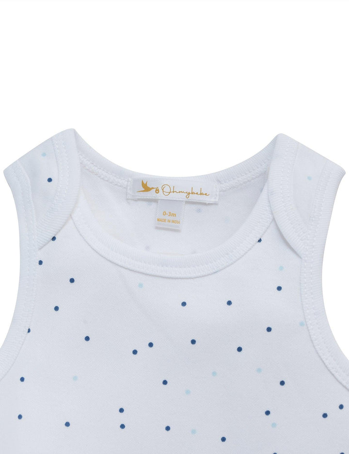 Close-up of the white organic cotton sleeveless bodysuit with a pattern of very small blue dots. Shop essential baby wear India.
