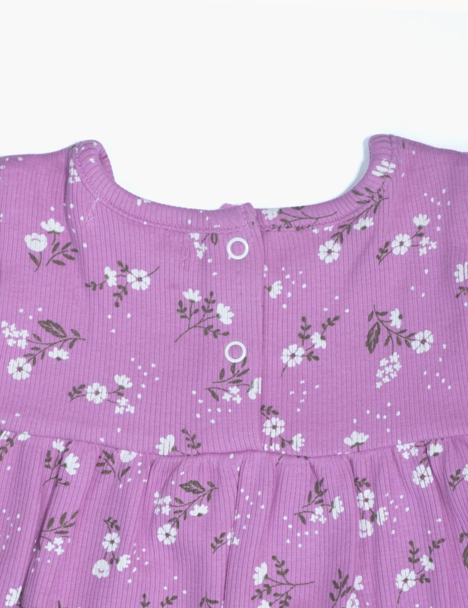 Purple organic baby romper with white daisy floral print and snap buttons on back