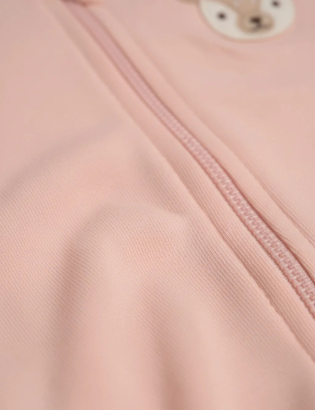Close-up of a pink fabric with a zipper