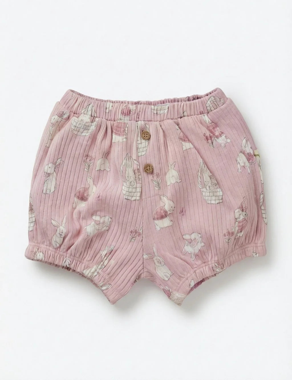 Light pink organic cotton baby bloomers with an all-over print of bunnies and baskets.