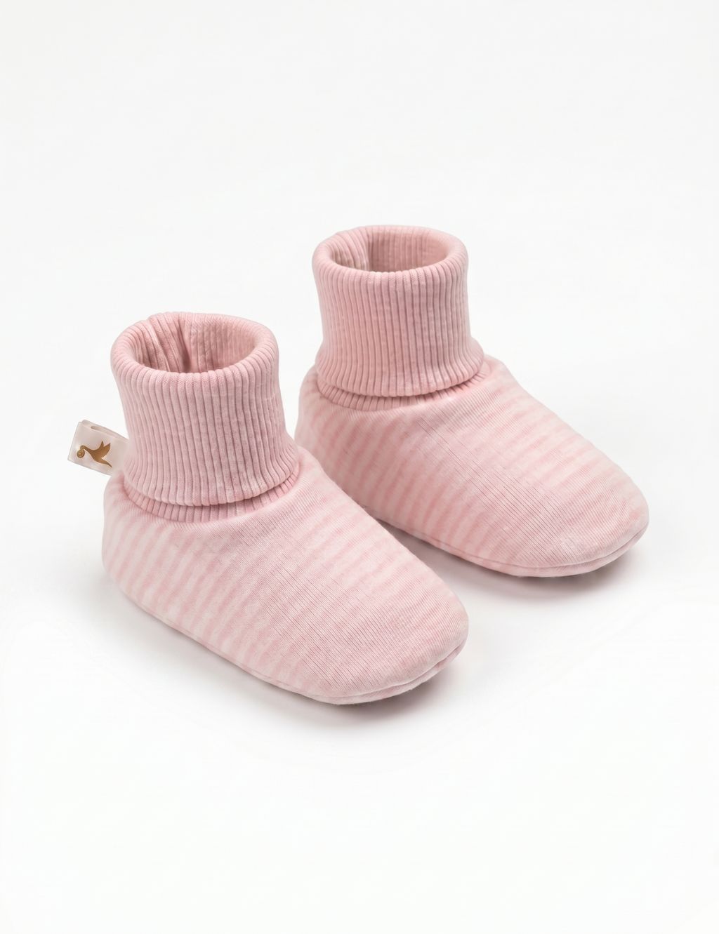A pair of soft light pink baby booties featuring thin stripes and solid pink ribbed cuffs, displayed against a plain white background.