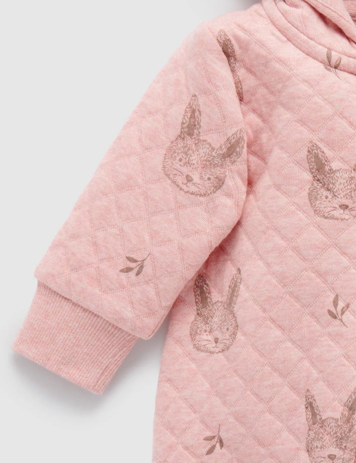 Sleeve detail of a soft pink quilted baby jumpsuit with an all-over bunny face and leaf pattern and a comfortable ribbed cuff. Find gentle baby clothing online in India.