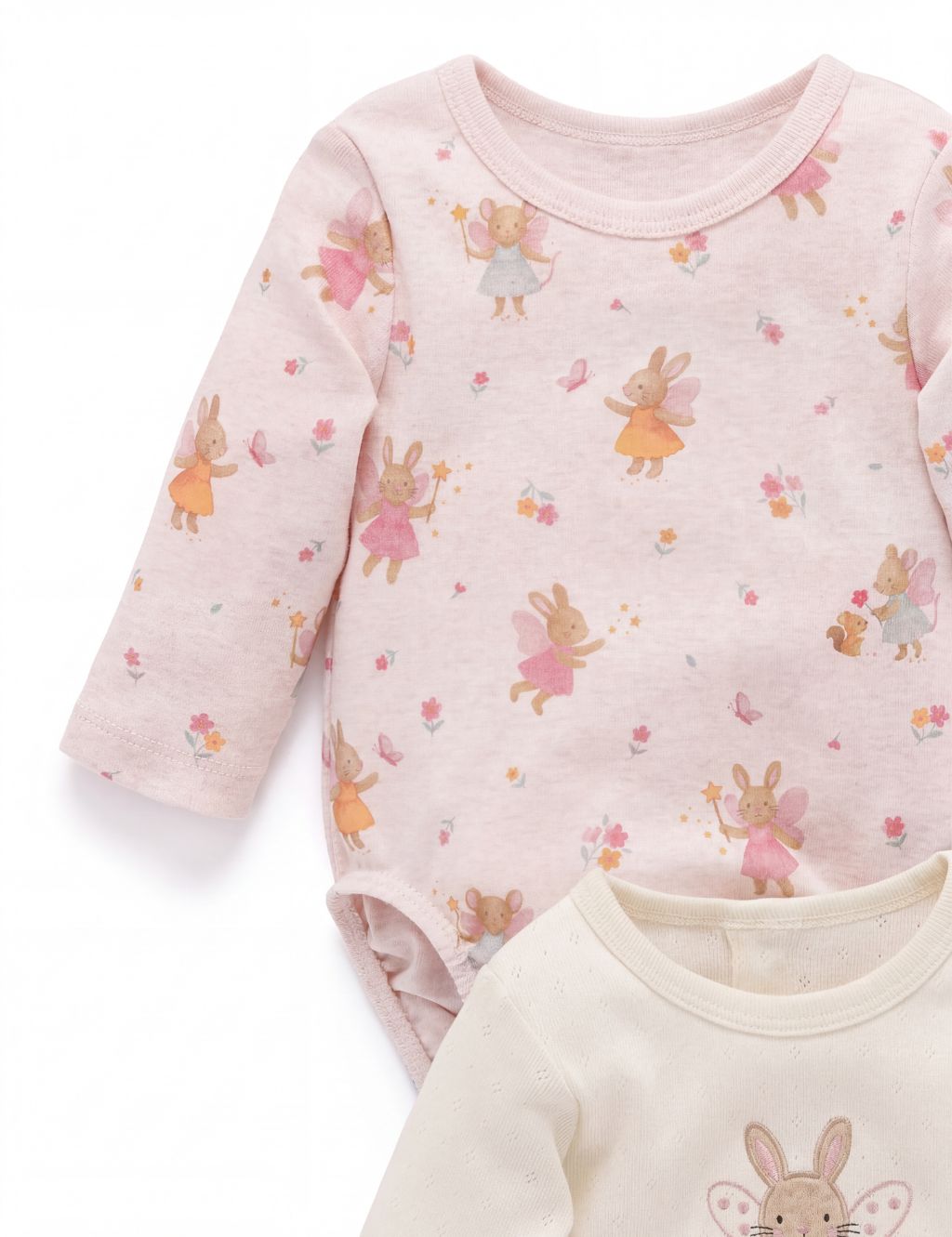 Close-up of a light pink long-sleeve baby bodysuit showcasing a whimsical all-over print of little bunny and mouse fairies.
